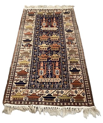 Lot 1405 - Afghan rug decorated with AK47's Tanks and Coffee pots on blue and cream ground, 215cm x 114cm