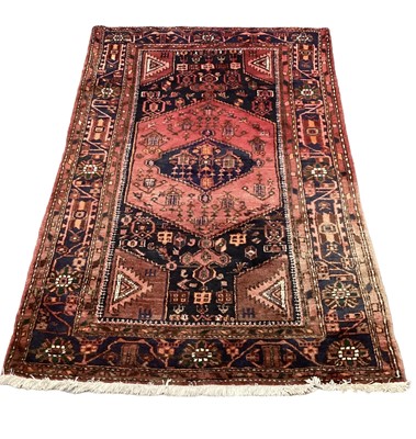 Lot 1407 - Eastern rug with central medallion on red and blue ground, 200cm x 131cm