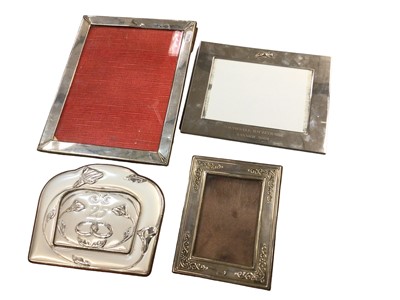 Lot 1120 - Group of four silver and white metal photo frames