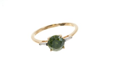 Lot 317 - Fancy green diamond ring with a round brilliant cut fancy green diamond (heat treated) estimated to weigh approximately 1.32cts. with tapered baguette cut diamonds to the shoulders on 18ct yellow g...