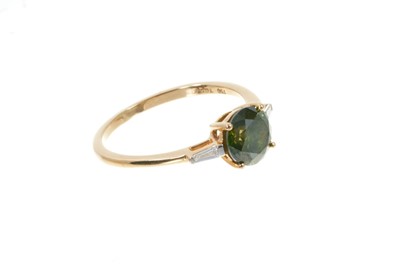Lot 317 - Fancy green diamond ring with a round brilliant cut fancy green diamond (heat treated) estimated to weigh approximately 1.32cts. with tapered baguette cut diamonds to the shoulders on 18ct yellow g...