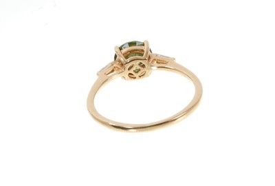 Lot 317 - Fancy green diamond ring with a round brilliant cut fancy green diamond (heat treated) estimated to weigh approximately 1.32cts. with tapered baguette cut diamonds to the shoulders on 18ct yellow g...