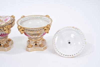 Lot 5 - Pair of early 19th century Derby pot pourri, of urn form, the rims pierced, with applied masks and paw feet on shaped bases, painted in pink enamel and gilt with foliate patterns, marked to bases,...