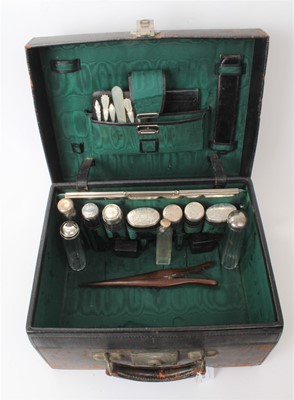 Lot 218 - Victorian leather toiletry case containing an assortment of silver topped bottles