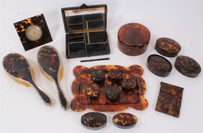 Lot 642 - Collection of tortoiseshell dressing table items, desk timepiece, vanity case, pair of silver mounted hairbrushes and similar items