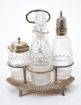 Lot 195 - Victorian silver four bottle cruet of elliptical form with reeded frame and central handle