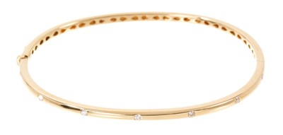 Lot 730 - 18ct yellow gold and diamond bangle, set with 14 round brilliant cut diamonds