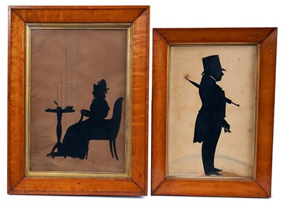 Lot 411 - Augustin Amant Constant Fidele Edouart (1788-1861) paper cut silhouette, lady seated at a table, knitting, signed and dated 1807, in glazed maple frame, total size 36 x 26cm, together with a simila...