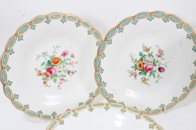 Lot 19 - Mid-19th century English porcelain dessert service, comprising sixteen plates, three footed dishes, and one centrepiece, painted with flowers on a blue and gilt fleur-de-lis border (20)