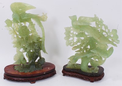 Lot 632 - Chinese jade or green hardstone carving depicting phoenix, on carved and pierced hardwood stand, 34cm high, together with a similar carving