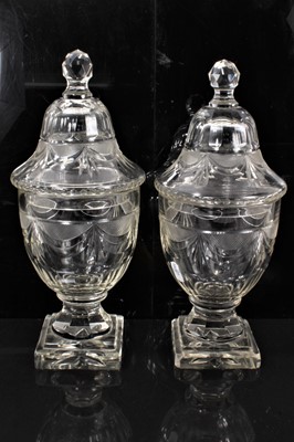 Lot 22 - Good quality pair of Regency cut glass covered urns, with swag decoration, on stepped square bases, 31cm high