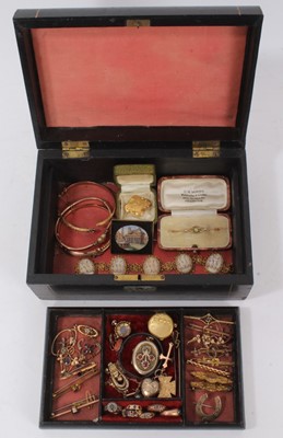 Lot 336 - A Victorian jewellery box containing a good group of Victorian and Edwardian jewellery to include three gold hinged bangles, six Victorian gold rings, three Edwardian gold pendants, a collection of...