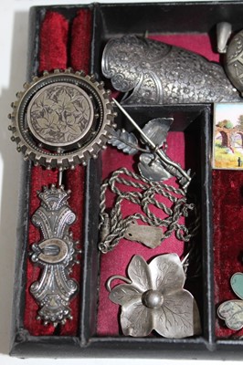 Lot 337 - A Victorian jewellery box containing a good collection of Victorian and Edwardian silver jewellery to include a Victorian silver posy holder/brooch, Victorian silver locket, Victorian name brooches...