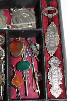Lot 337 - A Victorian jewellery box containing a good collection of Victorian and Edwardian silver jewellery to include a Victorian silver posy holder/brooch, Victorian silver locket, Victorian name brooches...