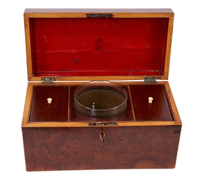 Lot 651 - Early 19th century figured yew wood tea caddy, with glass mixing bowl and flanking lidded compartments, 30cm wide