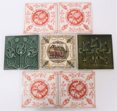Lot 40 - Group of antique tiles, including four Minton & Hollins printed in red with a pineapple pattern, two green Art Nouveau tiles, and one printed with a motto (7)