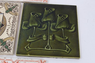 Lot 40 - Group of antique tiles, including four Minton & Hollins printed in red with a pineapple pattern, two green Art Nouveau tiles, and one printed with a motto (7)