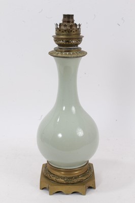 Lot 657 - 19th century French celadon porcelain lamp with brass mounts.