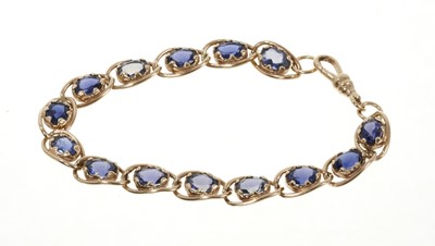 Lot 358 - 9ct gold and tanzanite bracelet, with oval mixed cut stones in 9ct yellow gold setting, 19cm.