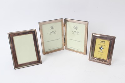 Lot 230 - Contemporary silver hinged, double photograph frame of rectangular form  and two others(