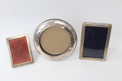 Lot 231 - Early 20th century silver photograph frame of circular form with easel back and two others