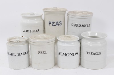 Lot 1413 - Group of seven late 19th/early 20th century white glazed kitchen storage jars, all titled in black, including 'Loaf Sugar', 'Treacle', etc