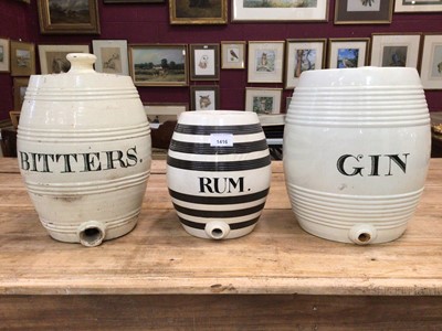 Lot 1416 - Three 19th century banded pottery spirit barrels, the largest 33cm high