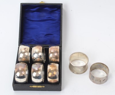 Lot 270 - Cased set of six George V silver napkin rings, and two others