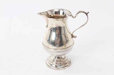 Lot 271 - Early George V silver cream jug of baluster form, with scroll handle