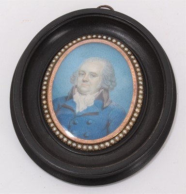 Lot 664 - Late 18th century oval portrait miniature on ivory depicting a gentleman in blue coat, within a double-sided oval gold glazed frame with seed pearl border, the reverse with a compartment of plaited...