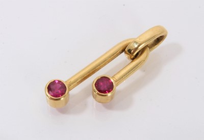 Lot 406 - Contemporary ruby and and 18ct gold pendant with two 3.8mm round mixed cut rubies estimated to weigh approximately 0.56cts in total, in collet setting on an inverted U-shaped tubular design.