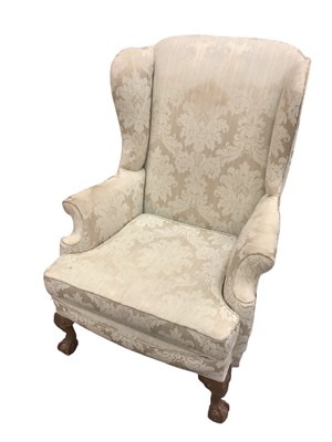 Lot 1186 - Georgian style wing armchair, on squat carved cabriole legs and claw and ball feet