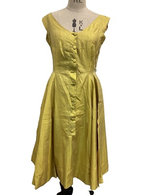 Lot 2100 - Worth gold raw silk button through dress with full skirt. 1970's Jean Allen evening dress with long sleeves and mico-pleating trim. 1990's Laura Ashley Made in HongKong linen and cotton dress with...