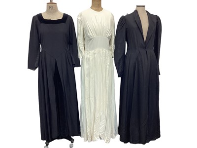 Lot 2103 - 1940's black fine stripe day dress and a black crepe evening dress, Edwardian unlined fitted long black coat with leg of mutton sleeves, a black evening dress with lace trim and a cream crepe weddi...