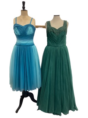 Lot 2104 - 1950's dresses including green lace and net ball gown by Acquer, blue pleated chiffon cocktail dress, dark pink bocade evening dress with bow detail and a blue satin evening gown with rhinestones a...