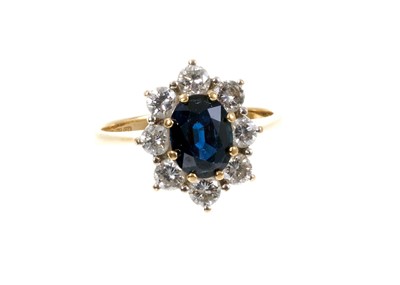 Lot 461 - Sapphire and diamond cluster ring with an oval mixed cut blue sapphire surrounded by eight brilliant cut diamonds in claw setting on 18ct gold shank