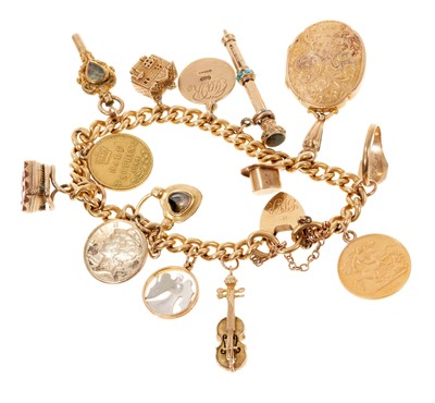 Lot 448 - Gold charm bracelet with a collection of gold and yellow metal charms to include a gold half sovereign