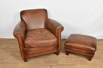 Lot 1089 - Leather upholstered club chair and footstool