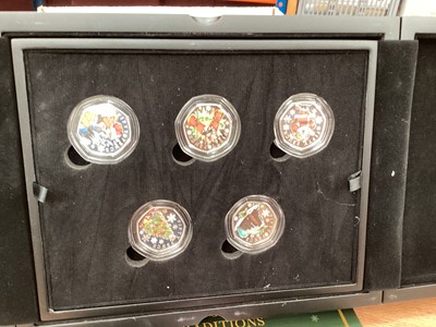 Lot 411 - World - Mixed silver proof colour enchanced 50p coin sets, each containing five coins to include Isle of Man Rupert Bear 2020 & Guernsey Christmas Traditions 2021 (N.B. Cased with Certificates of A...