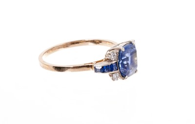 Lot 400 - Art Deco sapphire and diamond ring with a cushion shape mixed cut blue sapphire flanked by four diamonds and calibre cut blue sapphires to the tapered shoulders