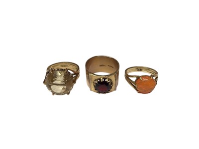Lot 34 - Late 1960s 18ct gold citrine cocktail ring, size N½, 1970s 18ct gold garnet cocktail ring on wide bark effect band, size P and one other dress ring, size N½, all bearing makers mark JE