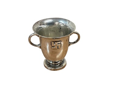 Lot 742 - George V silver two handled cup with applied Swastika decoration, (London 1911), 15.6cm in height.