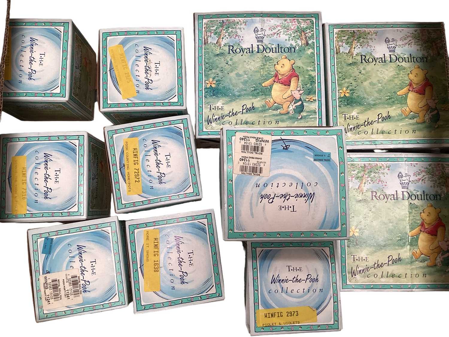 Lot 1189 - Eleven Royal Doulton Winnie The Pooh figures - Christopher Robin, Winnie The Pooh and the Paw-Marks, Christopher Reads to Pooh, Rabbit Reads the Plan, Christopher Robin and Pooh, Pooh and Piglet th...