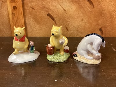 Lot 1189 - Eleven Royal Doulton Winnie The Pooh figures - Christopher Robin, Winnie The Pooh and the Paw-Marks, Christopher Reads to Pooh, Rabbit Reads the Plan, Christopher Robin and Pooh, Pooh and Piglet th...