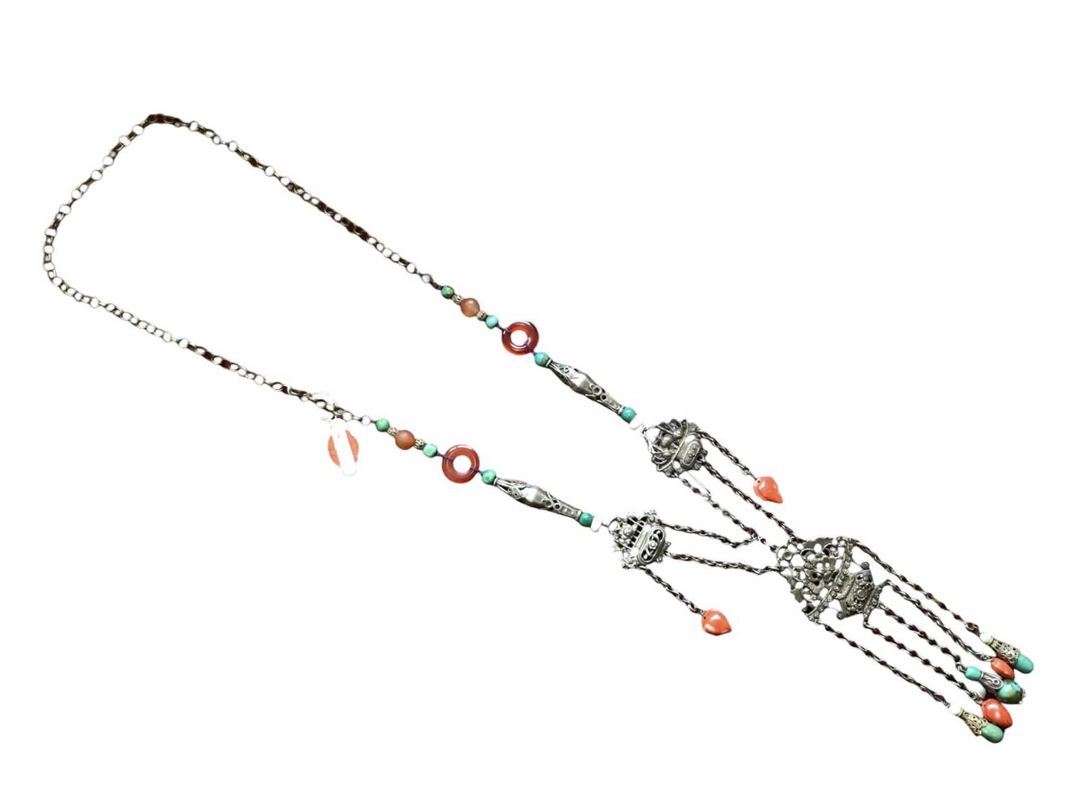 Lot 2 - Old Chinese white metal necklace with pierced floral scroll panels, carved coral and turquoise drops suspended from chains and further beads interspaced on the chain.