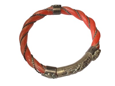 Lot 3 - Old Chinese coral carved rope twist bangle with white metal mounts, a similar coral ring and four pairs of coral drop earrings