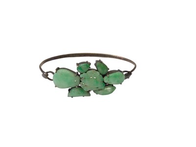 Lot 8 - Chinese silver bangle mounted with seven green jade/ hard stone panels, together with four Chinese silver and green jade/ hard stone rings and a similar pair of earrings