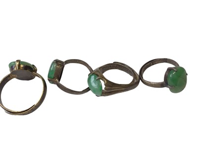 Lot 8 - Chinese silver bangle mounted with seven green jade/ hard stone panels, together with four Chinese silver and green jade/ hard stone rings and a similar pair of earrings