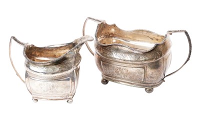 Lot 284 - George IV silver twin handled sugar and matching cream jug, with engraved decoration