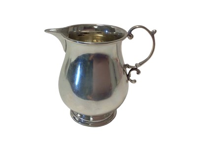 Lot 291 - George V silver cream jug of baluster form with sparrow beak pouring lip and scroll handle